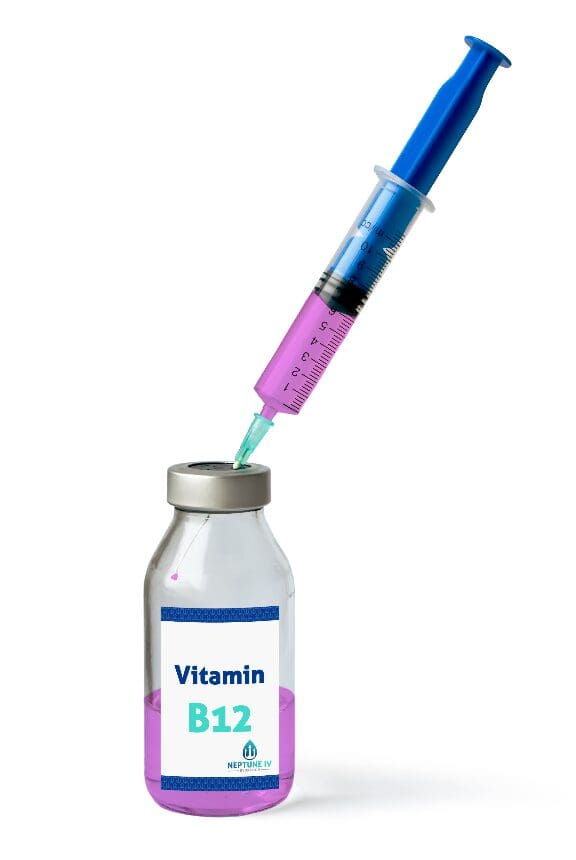 A syringe drawing liquid from a vial labeled "vitamin B12" for IV hydration
