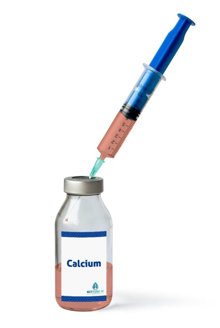 Syringe drawing liquid from a vitamin supplement vial against a white background.