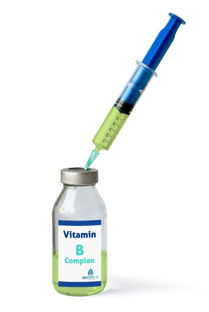 A syringe drawing a bright green liquid from a vial labeled "vitamin b complex" for mobile iv therapy.